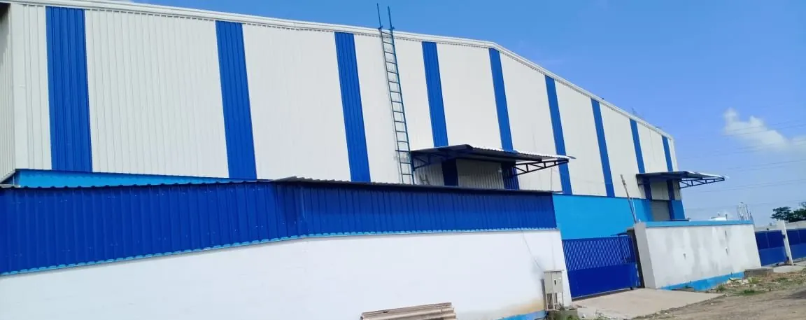 ART Warehouse exterior — blue and white steel building