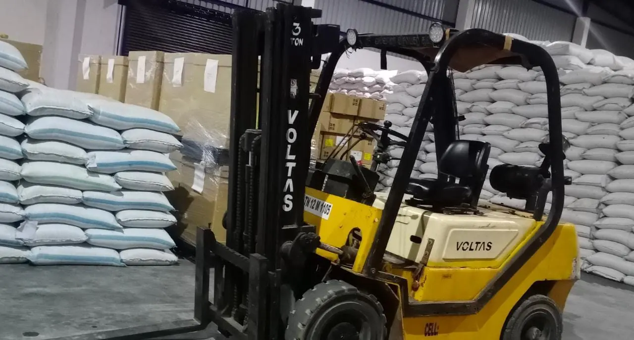 Forklift handling stacked sacks and cartons